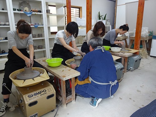 Hoffman Agency team doing wheel pottery
